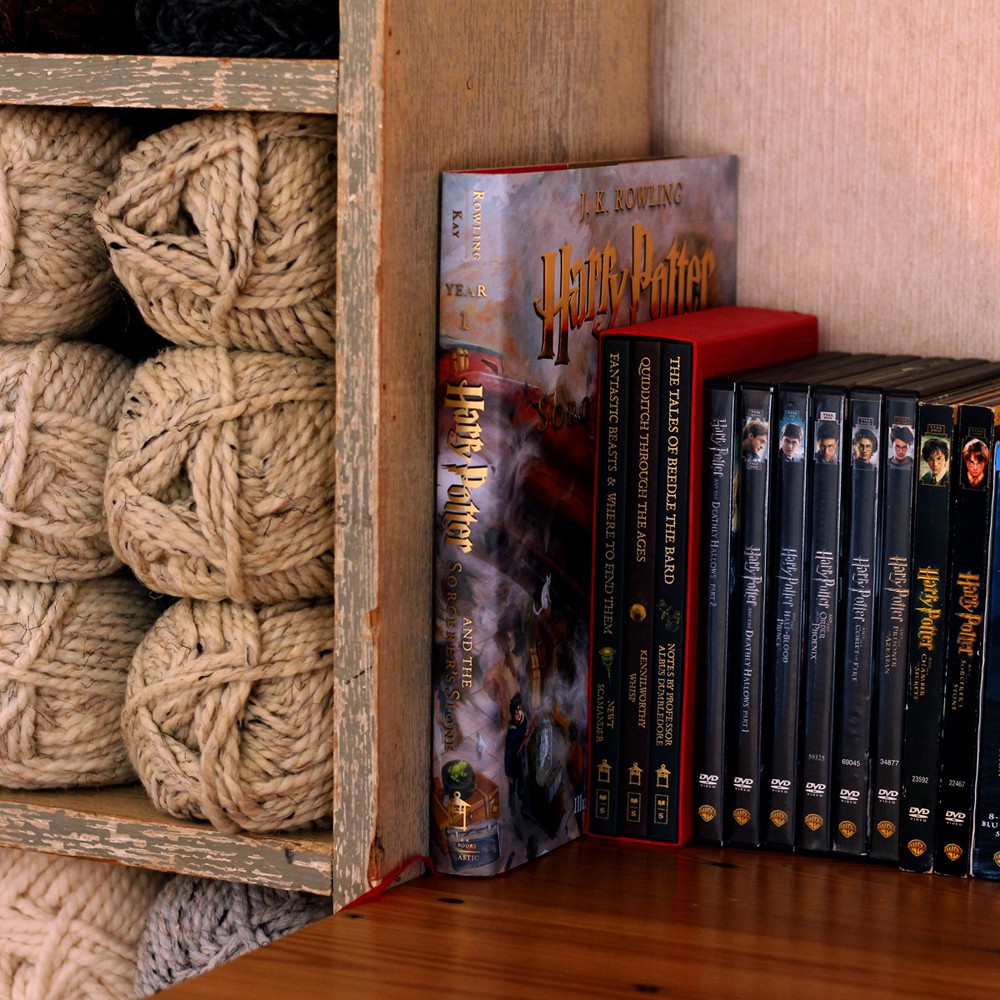display of harry potter books & movies next to the book shelf