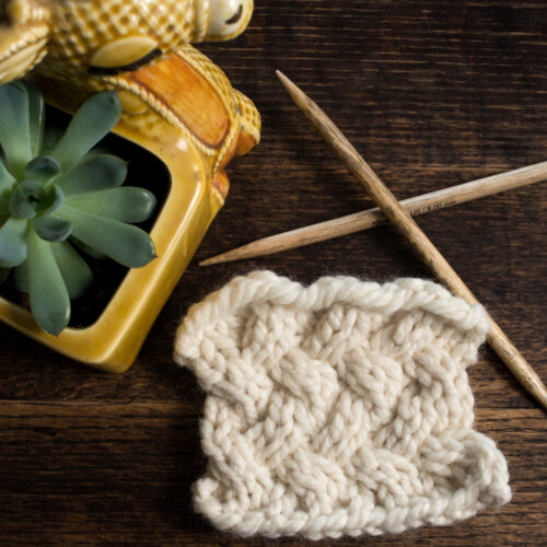 Swatch of the Lattice Knitting Stitch Pattern on a wood table.