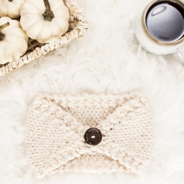 chunky knit headband on a fur blanket with knitting needles & a coffee