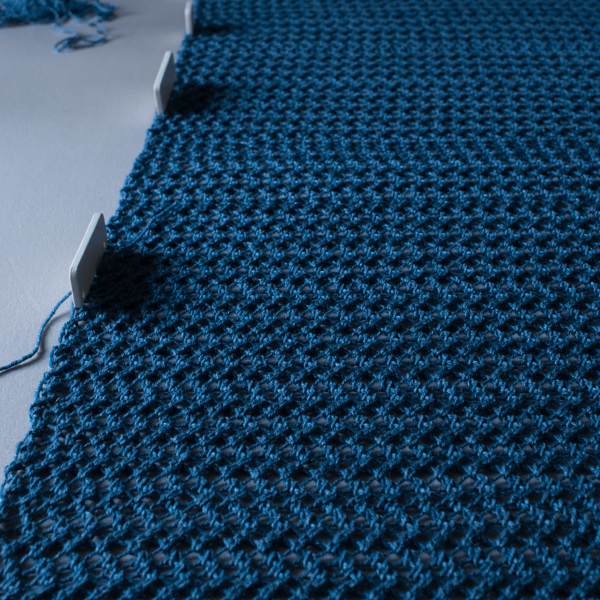 knitted blanket being blocked