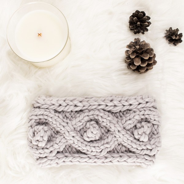 pic of a knitted cable headband on a faux fur blanket