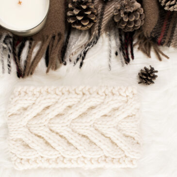 cable knit headband on a fur blanket with pumpkins & a coffee