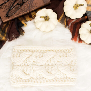 cable knit headband on a fur blanket with pumpkins & a coffee