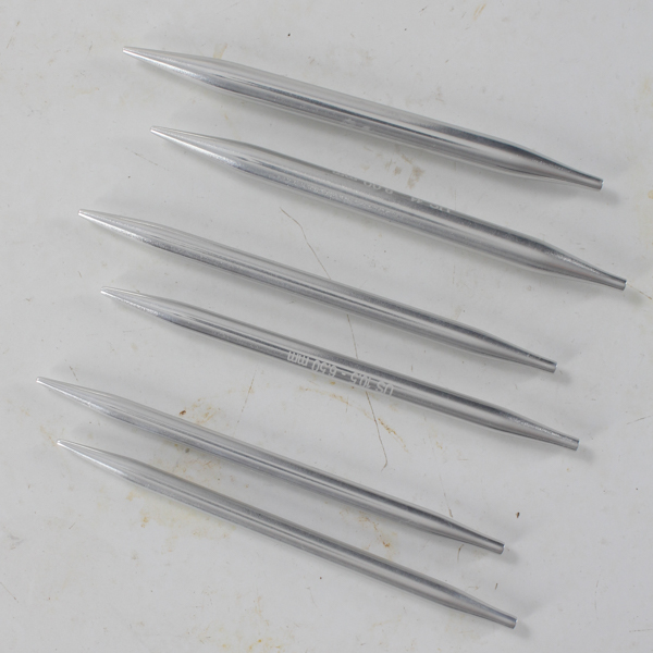 interchangeable needle set laying on a metal table