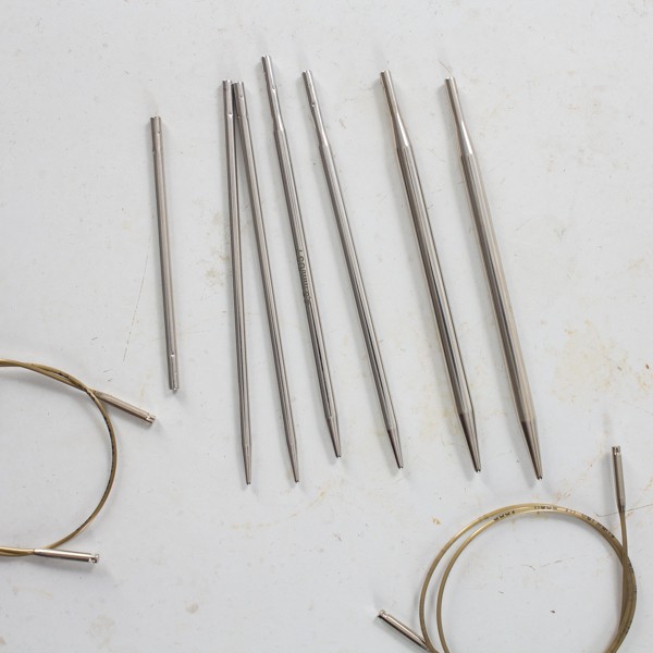 interchangeable needle set laying on a metal table