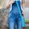 Model wearing the knitted water bottle sling