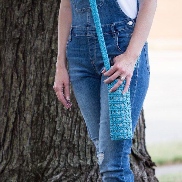 Model wearing the knitted water bottle sling