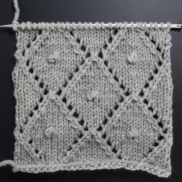 Front side of the Diamonds & Knots Lace Knit Stitch swatch