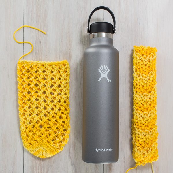 Knitted yellow water bottle sling by a hydro flask.