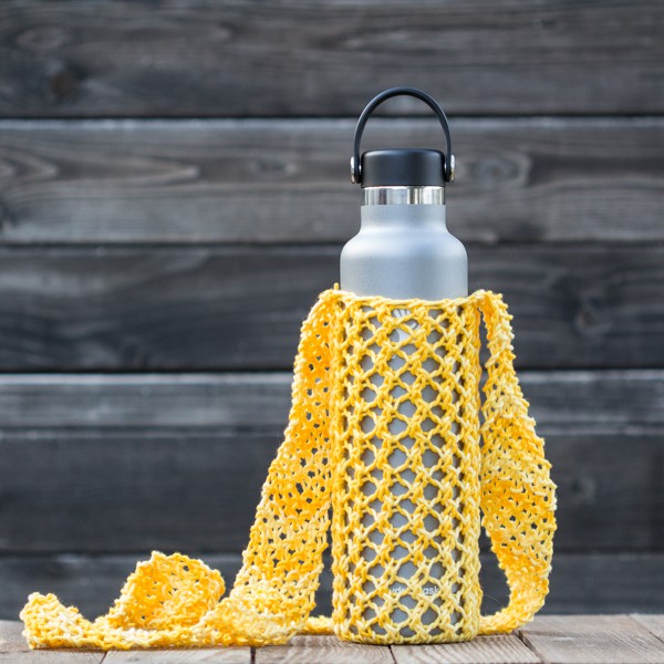 Knitted yellow water bottle sling in a hydro flask.