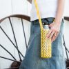Knitted yellow water bottle sling in a hydro flask.
