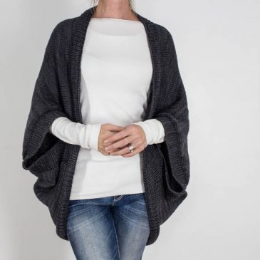 model wearing a hand knit, worsted weight scoop shrug