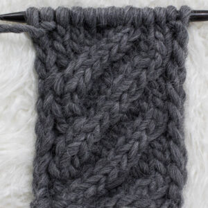 Swatch of the Basic 4-Step Cable Knit Stitch on a fur blanket.