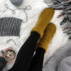 knitted socks on a fur blanket