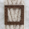 knit chevron scarf on a fur blanket with a gauge