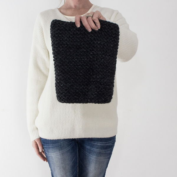 knit cowl on held in front of a model