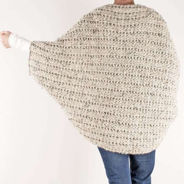 model wearing a hand knitted shrug, from the back