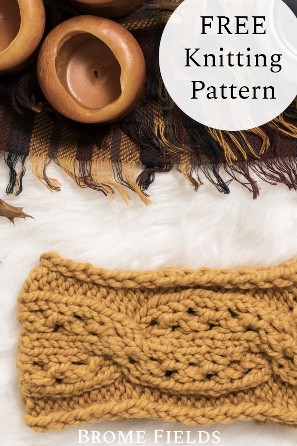 knit headband on a fur blanket with a plaid blanket and candles
