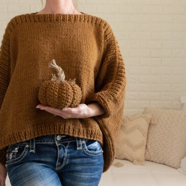a model wearing a hand knitted modern poncho sweater
