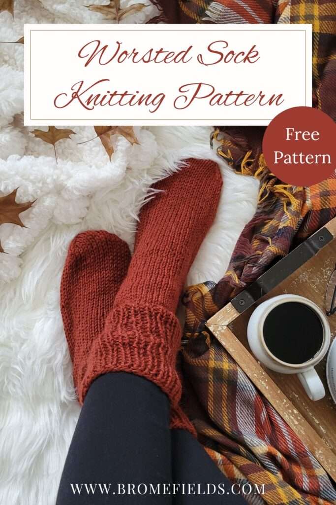 a cozy setting with worsted knitted socks, coffee, leaves on a fur blanket.