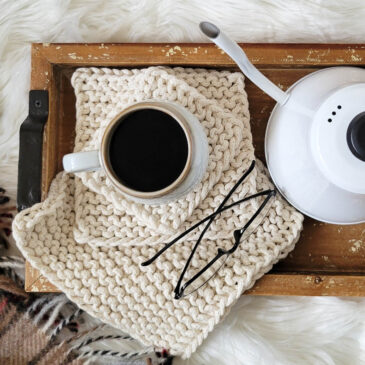 farmhouse knit potholders on a wooden tray, mug & coffee pot