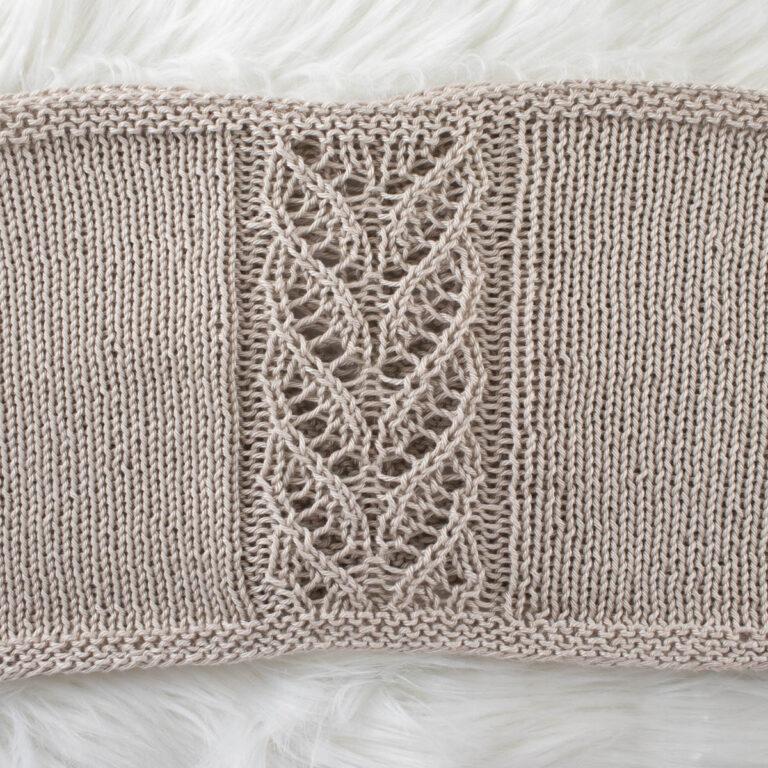 a knitted bralette laying flat on a blanket
