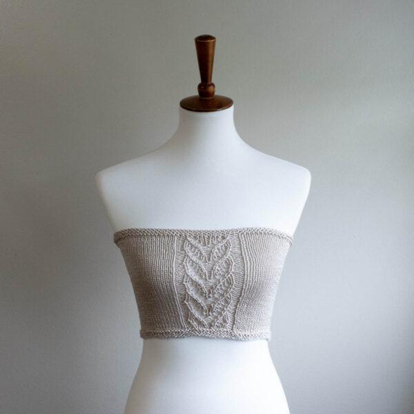 Dress form wearing a hand knit crop top.