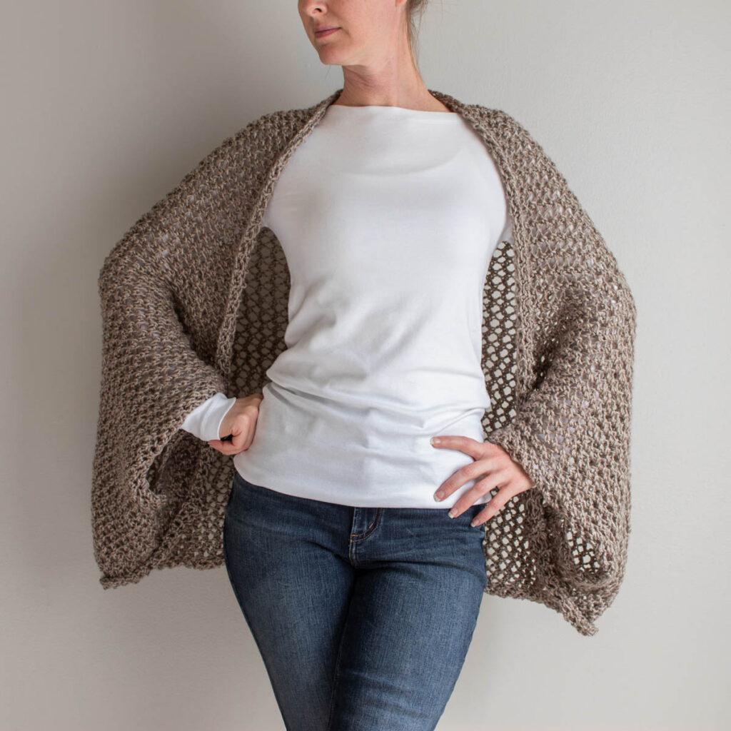 Photo of a summer lace knit shrug on a model.