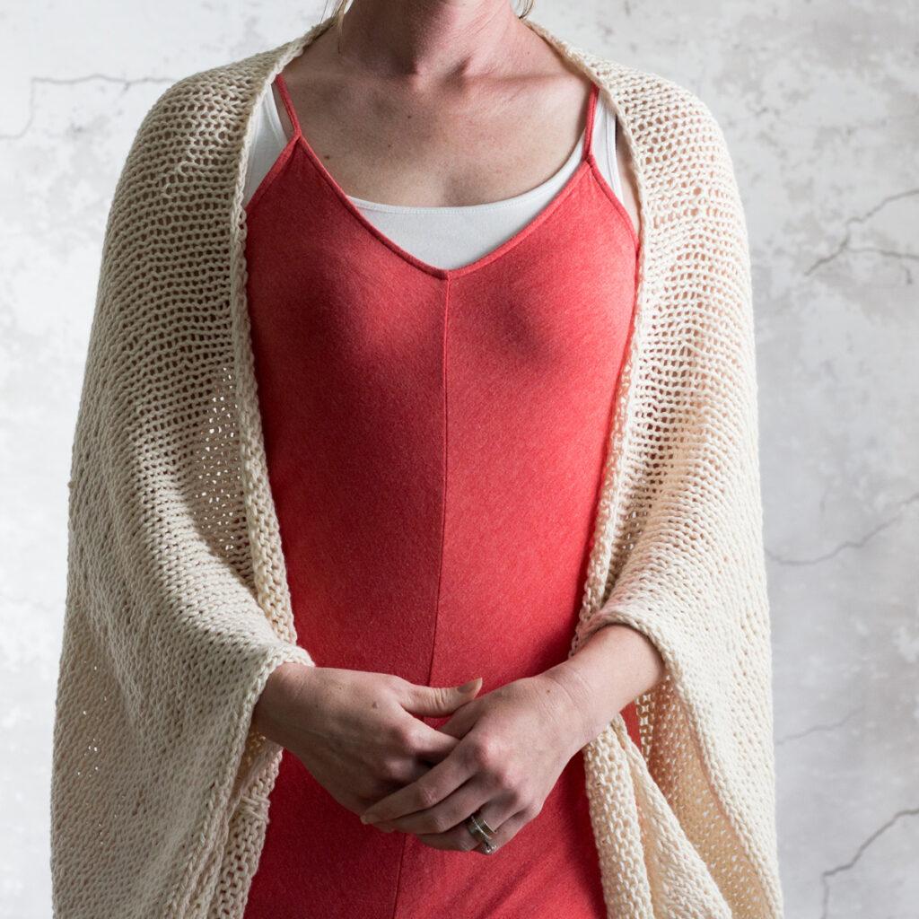 Photo of a simple cotton knit shrug on a model.
