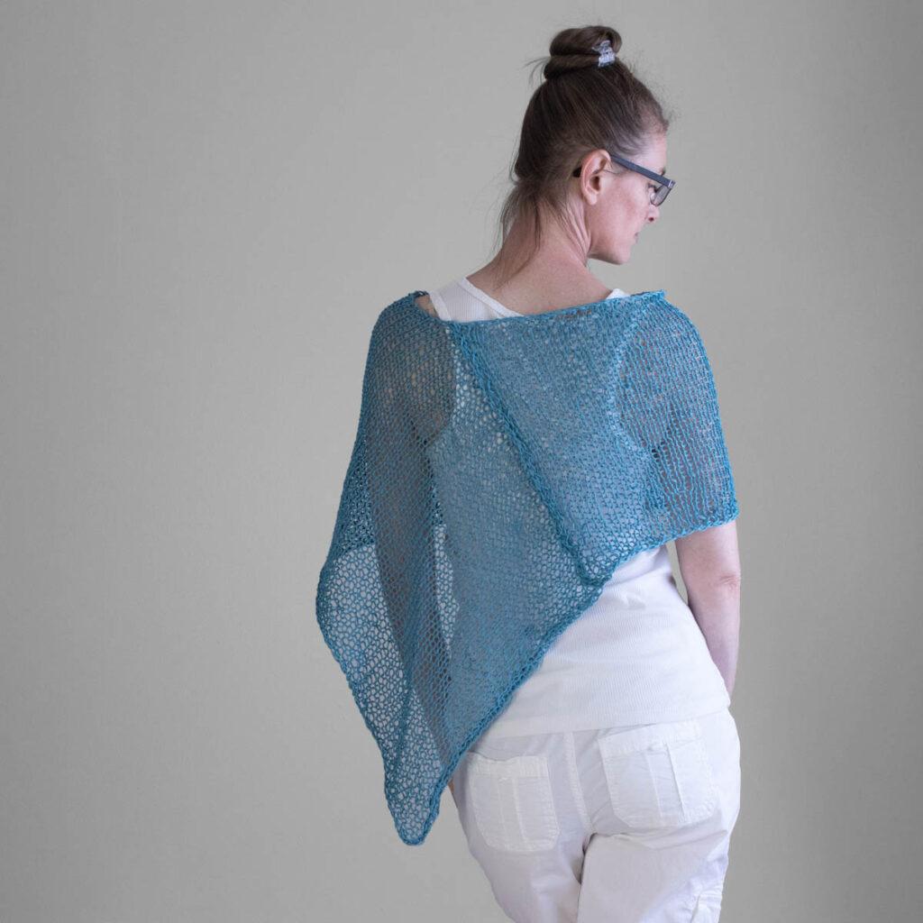 Photo of the poncho on a model showing the seam.