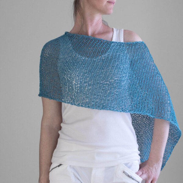 Front view photo of the hand knit poncho on a model.