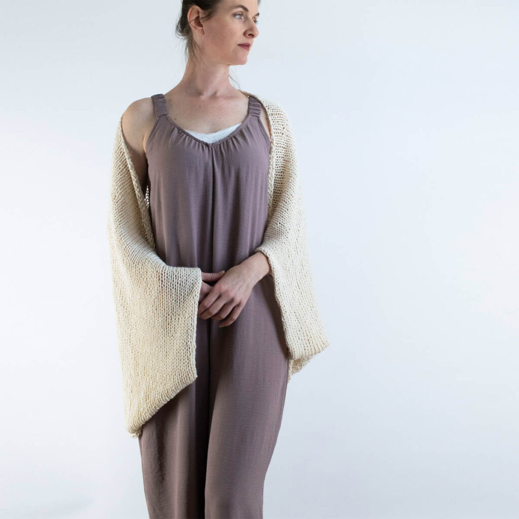 Easy knit shrug pattern using cotton yarn worn over a sleeveless jumper.