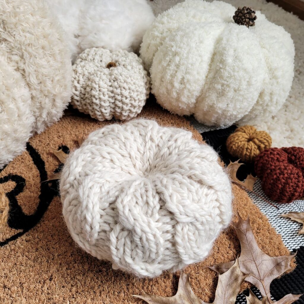 cable knitted pumpkin & several hand knit pumpkins
