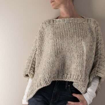 model wearing a hand knitted poncho sweater