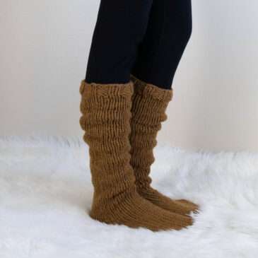 model wearing hand knit thick tall socks