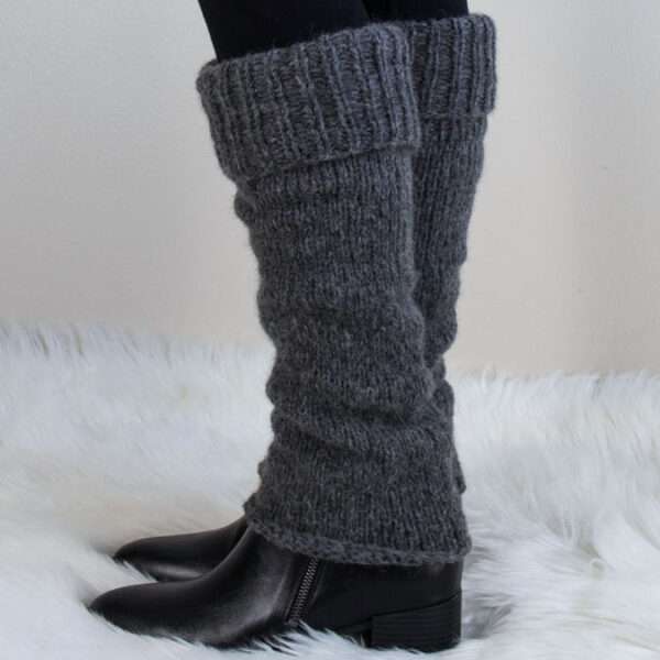 Model wearing hand knitted fuzzy leg warmers with boots