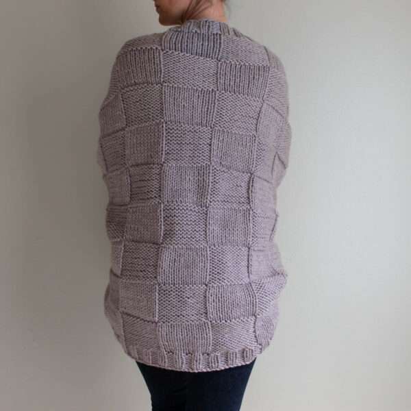 model wearing a hand knit patchwork shrug