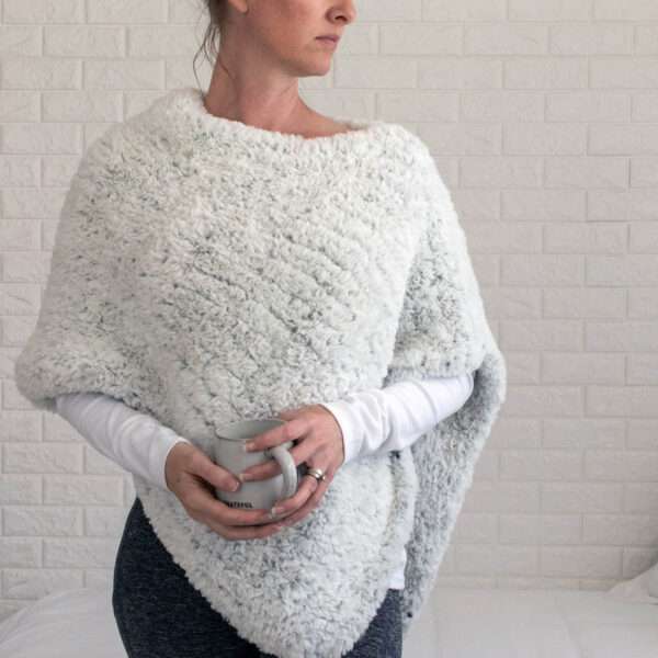 model wearing a hand knit faux fur poncho