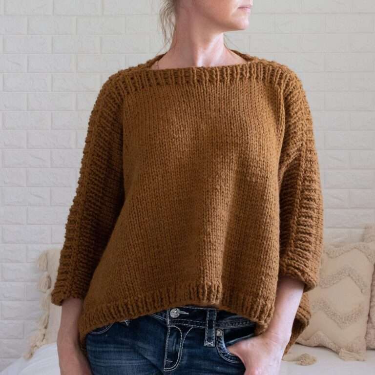 a model wearing a hand knitted modern poncho sweater