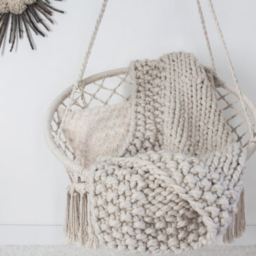jumbo knit blanket displayed on a macrame swing