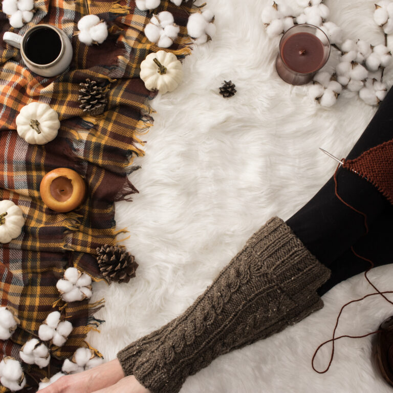 cable knit leg warmers on a faux fur blanket in a cozy setting