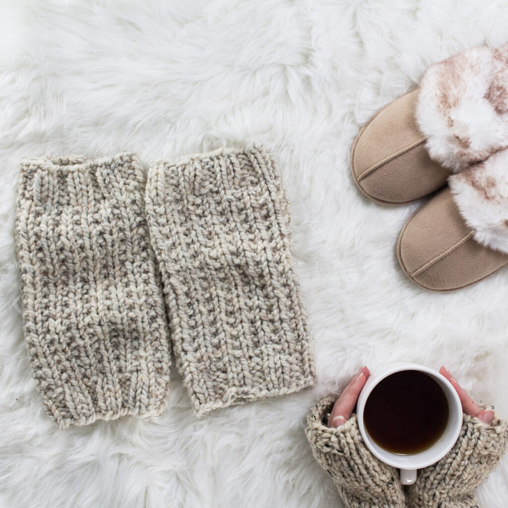 chunky knit leg warmers on a faux fur blanket in a cozy setting
