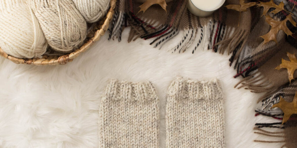 modern knit leg warmers on a faux fur blanket in a cozy setting