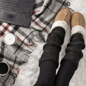 two needle leg warmers on a model a faux fur blanket in a cozy setting