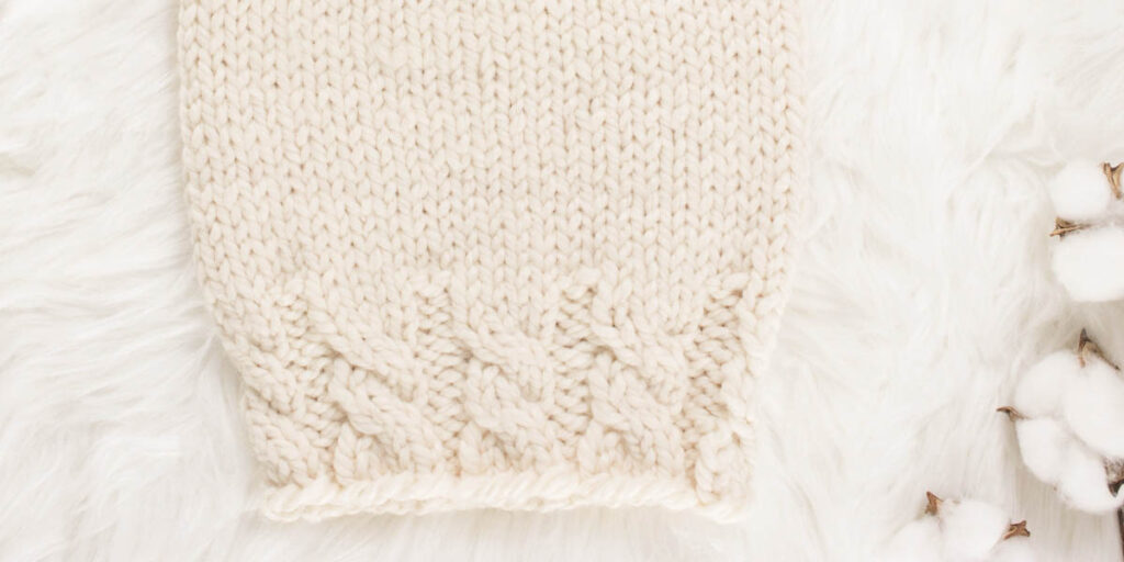 up-close pic of a hand knit chunky cable hat