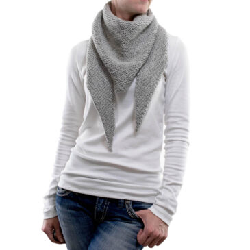 a knitted triangle scarf on a model