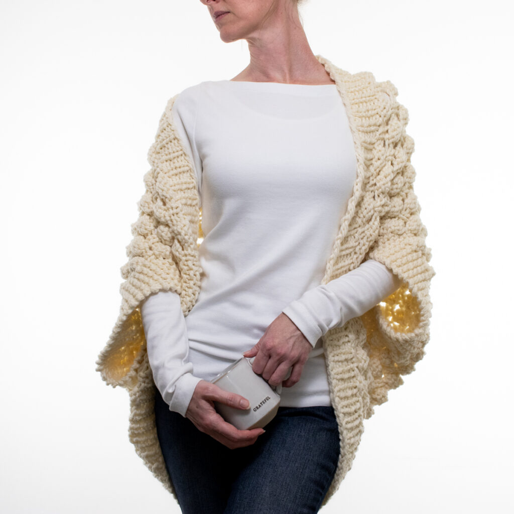 Oversized chunky lace knit shrug on a model.