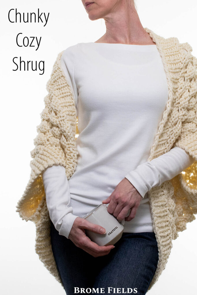 Oversized chunky lace knit shrug on a model.