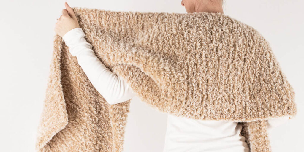 faux fur knitted rectangle shawl on a model.