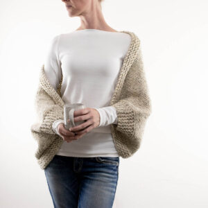 Knitted cropped shrug on a model.